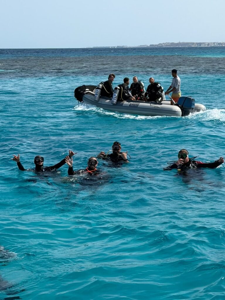Snorkellers in the water beside a dinghy