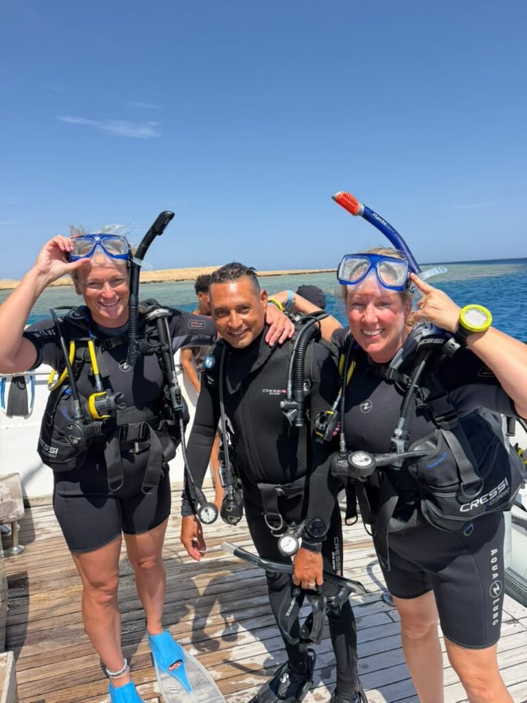 Guide with two divers on the deck