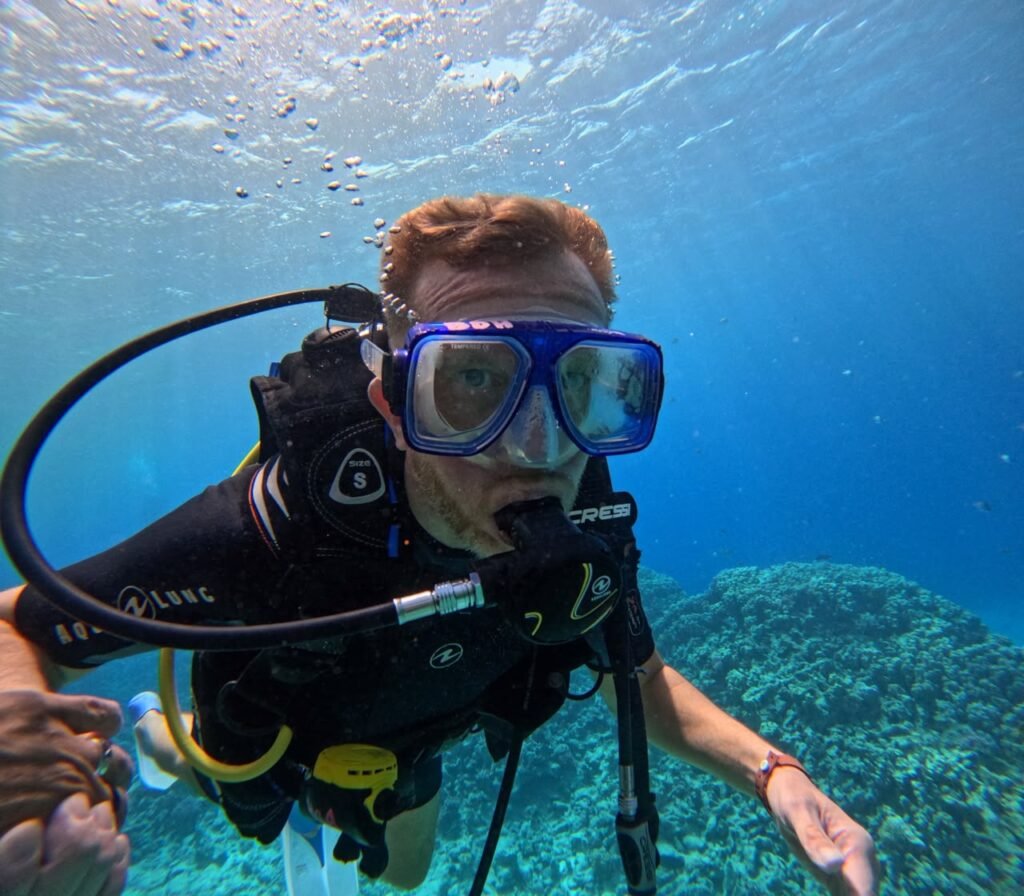 Instructor guiding a diver underwater